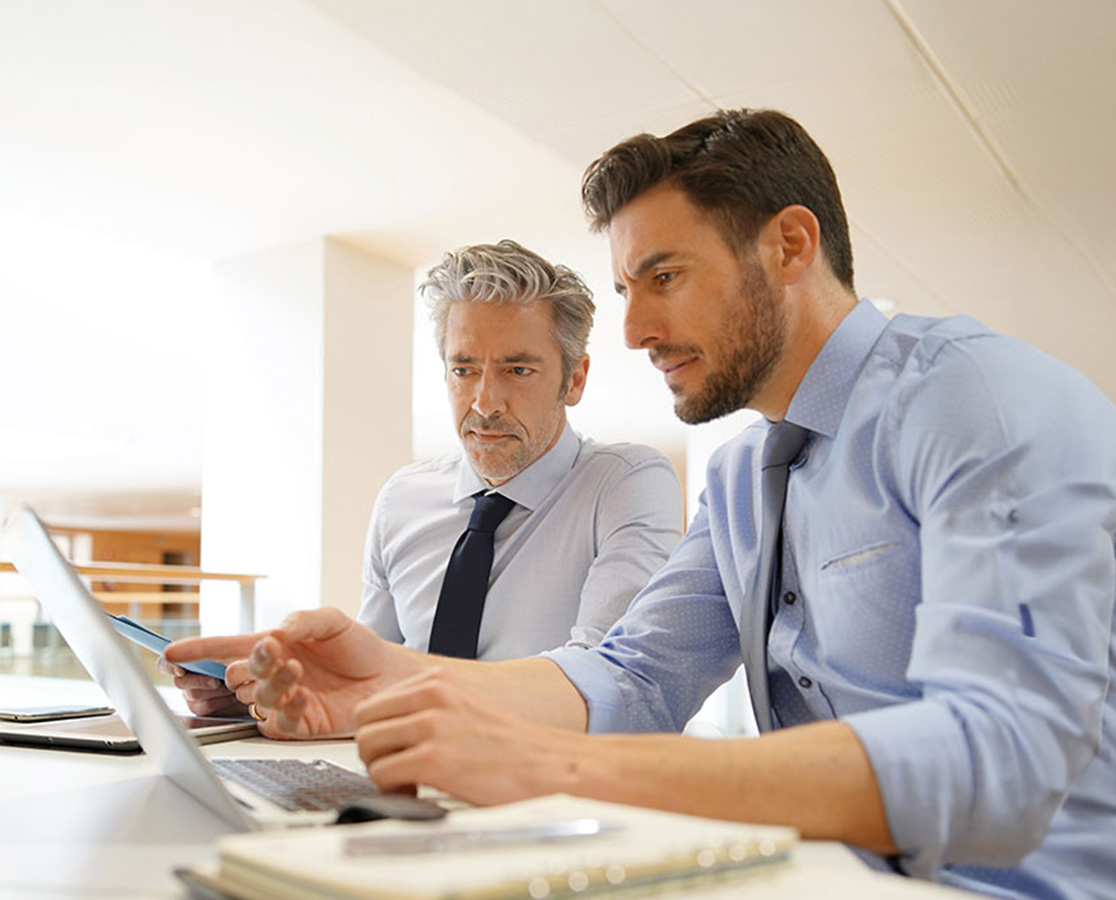 two businessmen consulting with one another