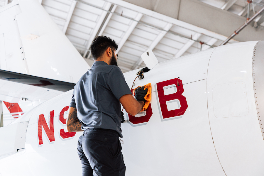 aircraft mechanic performing maintenance on a private jet